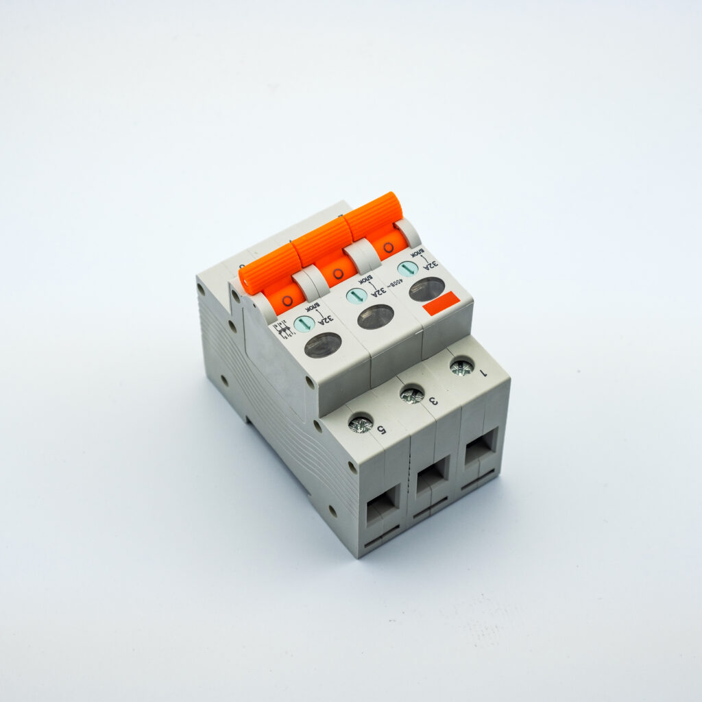 A white electrical circuit breaker with three orange switches and several gray and black buttons, set against a plain white background.